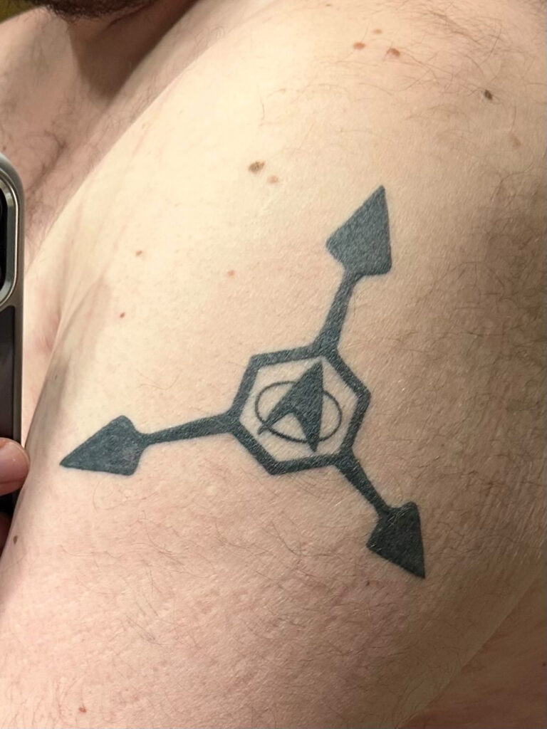 Geometric black ink tattoo by Elisha Marie