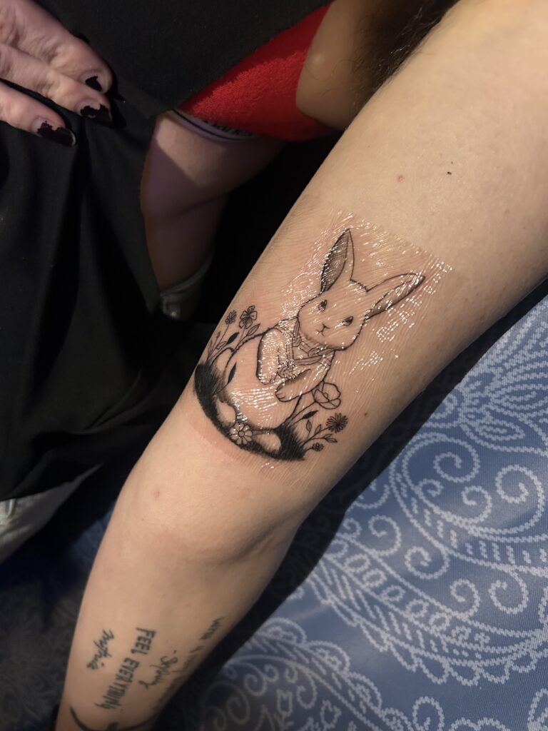 Real rabbit and floral tattoo created by Elisha Marie
